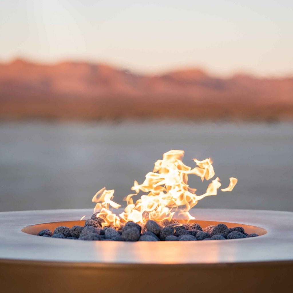 The Outdoor Plus 46" Outback Cattle Ranch GFRC Metallic/Rustic Top and Powdered Steel Base Round Natural Gas Fire Table - Match Lit with Flame Sense