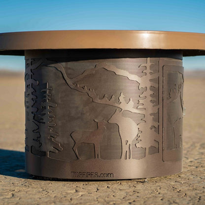 The Outdoor Plus 46" Outback Deer Country GFRC Top and Powdered Steel Base Round Liquid Propane Fire Table - Match Lit